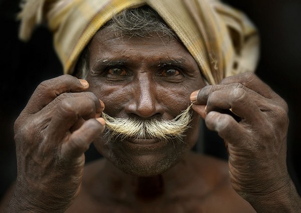 Man curling his moustache, India