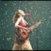 Female guitarist singing on stage under falling confetti, cinematic photography