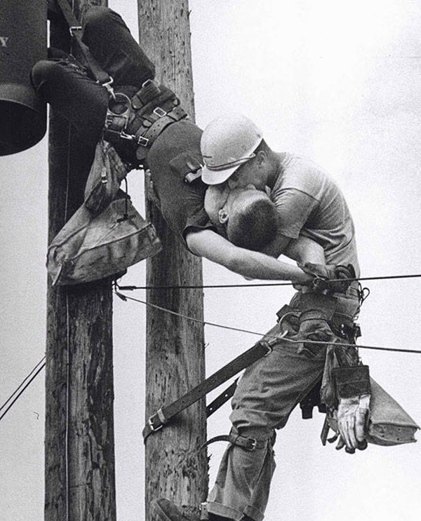 A utility worker giving mouth-to-mouth to a co-worker after he contacted a high voltage wire in 1967.