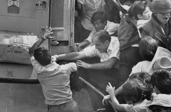 An American evacuee punches a South Vietnamese man for a place on the last chopper out of the US embassy during the evacuation of Saigon in 1975.