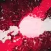Abstract red and white paint splatter explosion on a dark background