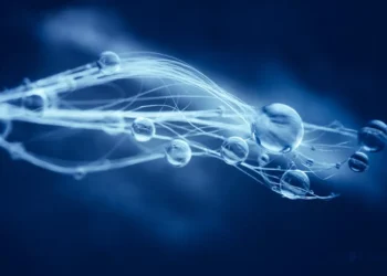 Glowing water droplets on delicate threads against a deep blue background