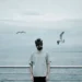 Calling His Life A Messy Heap Of Shades - Paolo Barretta Shoots Gems 43 Man in a gas mask standing by the sea with seagulls, fine art photography