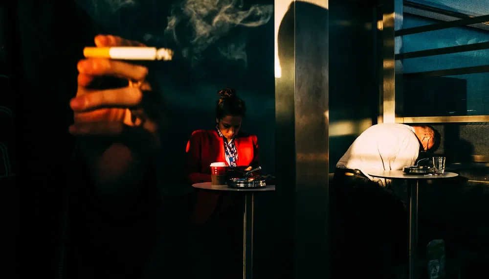 Italian Photographer Giacomo Vesprini Shoots The Invisible Elements In Street Photography 29 Smoky street scene with two strangers in dramatic light and shadow