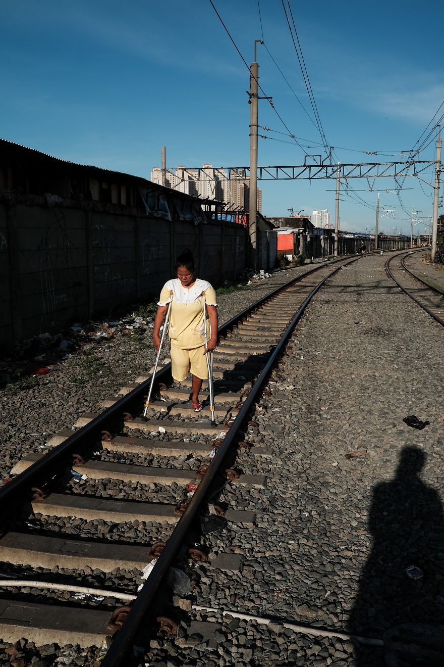 Woman With One Leg Is Walking On The Active Railway Tracks In A Slum Area Next To Jakarta Kota Train Station