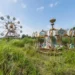 Abandoned carousel and ferris wheel overgrown with weeds in Japan