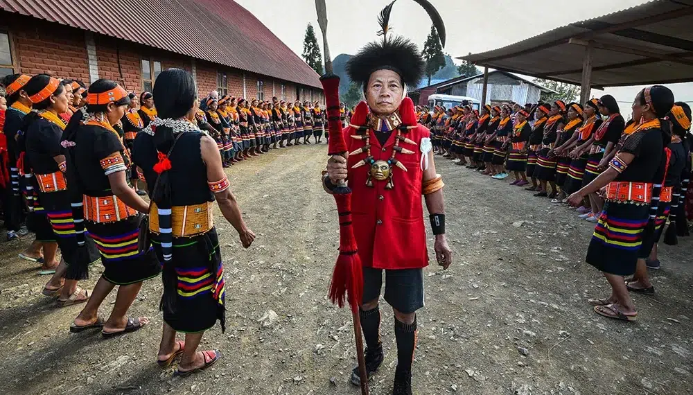 Aoling Festival: Beholding The Konyak Tradition By Tania Chatterjee 16 Konyak tribal elder in red coat leading Aoling festival ceremony, Nagaland