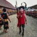 Konyak tribal elder in red coat leading Aoling festival ceremony, Nagaland