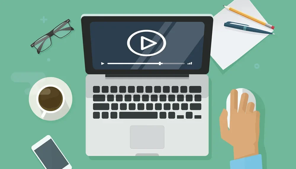 Flat design illustration of a laptop playing video, surrounded by office items