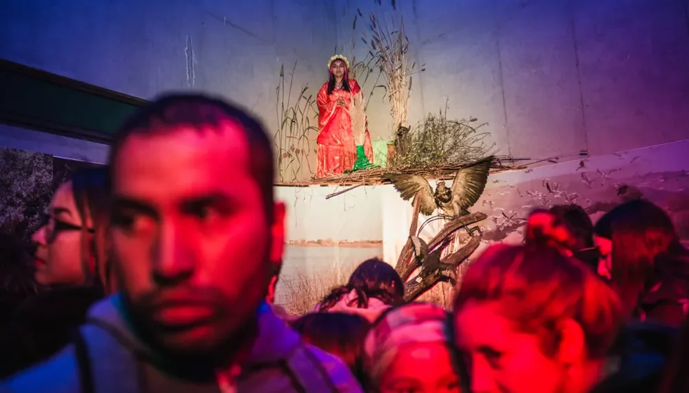 My Personal Best: Documentary Photographer Felipe Malhue Ortiz 1 Crowd watching a woman in red sitting on a staged installation indoors