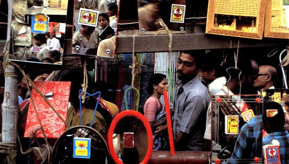 Street scene reflected in hanging mirrors at a busy market