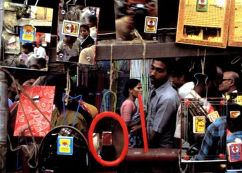Street scene reflected in hanging mirrors at a busy market