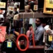 Street scene reflected in hanging mirrors at a busy market