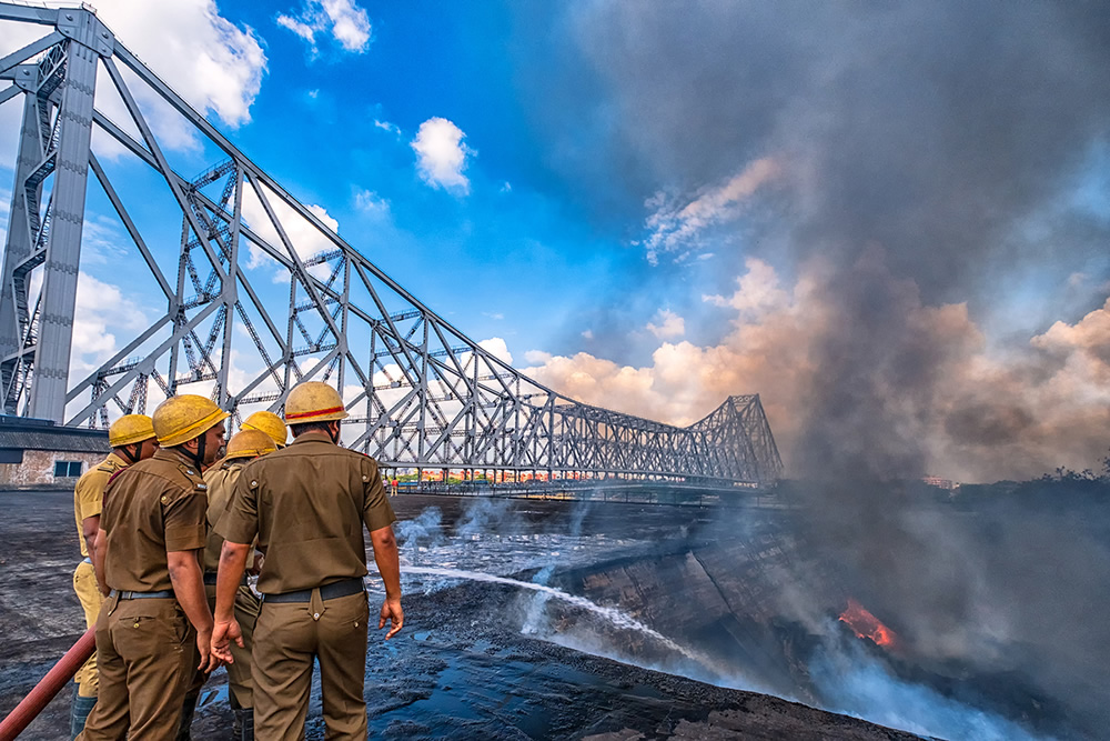 Firefighters doing their job near the iconic Howrah Bridge