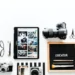Flatlay of cameras, tablet, phone, and a letter board reading "CREATOR"
