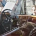Boy peering into a vintage car window, candid street photography