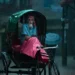 Elderly rickshaw driver sheltering under canopy during heavy monsoon rain, Dhaka