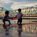 Kolkata: The Absolute Paradise For Street Photographers 71 Two children playing with red cloth by Howrah Bridge at dusk