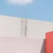 Ladder against a white wall beside a pink building under a blue sky