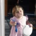 20 Funny Photos Of Parenting That Will Make You Laugh 33 Toddler in pink dress holding a spoon and bowl with food on her face — funny parenting pictures