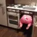 30 Funny & Hilarious Photos Of Kids Whose Parents Don’t Know Whether to Laugh or Cry 131 Toddler in pink onesie wedged inside a real kitchen oven funny pictures of kids