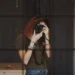 A girl taking a mirror selfie with a DSLR camera, face obscured by the lens