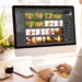 Woman editing fashion photos in photo library software on desktop computer
