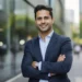 How To Take A Headshot: Tips From A Professional Headshot Photographer 17 Professional male headshot with arms crossed, smiling in an outdoor setting