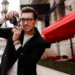 Stylish man with glasses taking photos on a film camera outdoors
