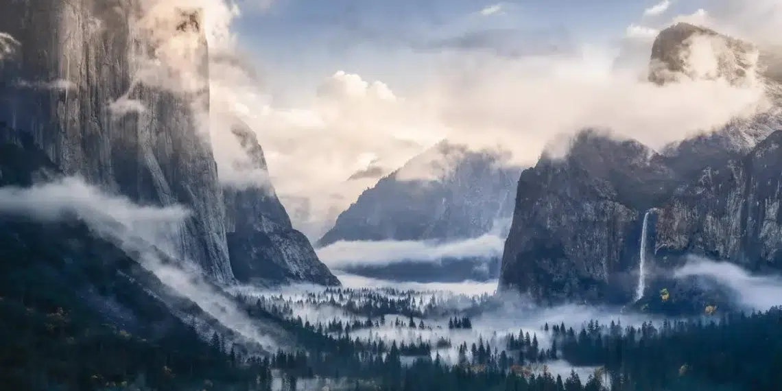 Misty Yosemite Valley with granite cliffs and waterfall, landscape photography