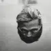 Man's face half-submerged in water, black and white film photography