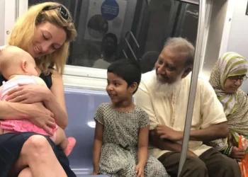 Strangers sharing smiles over a baby on a subway heartwarming street photography
