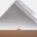 Silhouetted camels by a giant pyramid in the desert