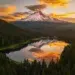 30 Stunning Landscapes That Will Make You Want to Travel the World 63 Snow-capped Mount Hood reflected in a forest lake under a fiery sunset - breathtaking landscape photography