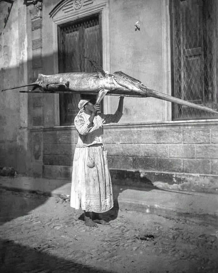A woman from Bagnara carrying a swordfish on her head Calabria, Italy, 1945