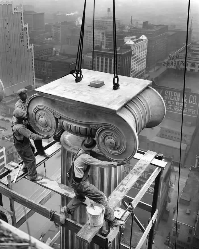 Workers installing a Greek Revival architectural column on the Civil Courts building in St. Louis, Missouri, 1928. (Photo by W.C. Runder).