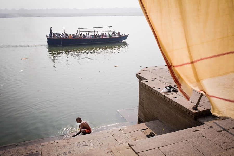 Ghats of Ganges Varanasi People Traveling in boat and bathing India - Captivating Street Photography by Giancarlo Zuccarone