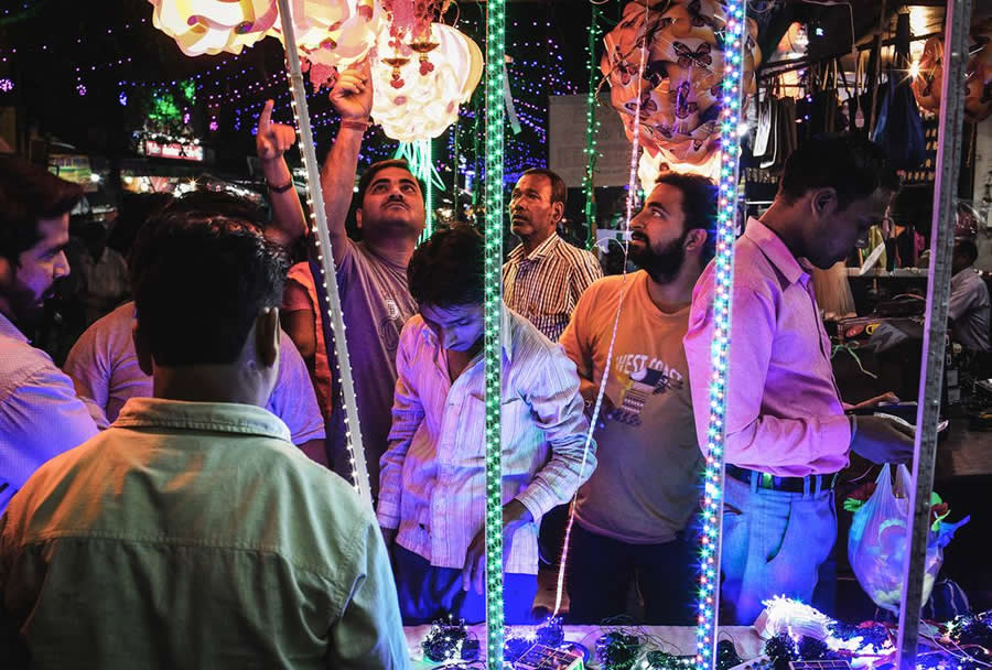 Night Street Photo with lights and people watching - Captivating Street Photography by Giancarlo Zuccarone