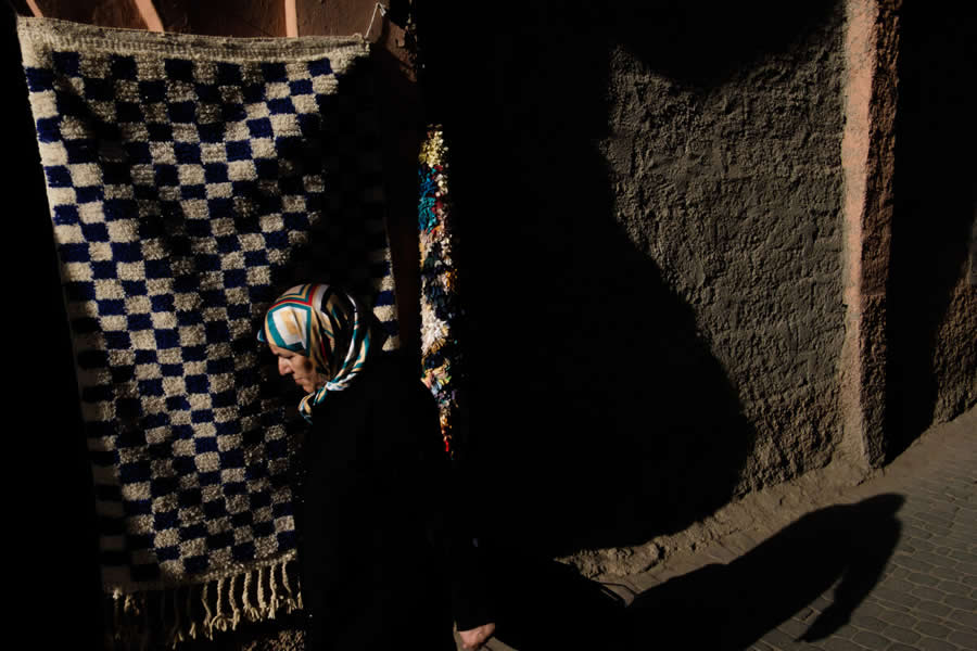 Lady Walking on street with long shadows and colors - Captivating Street Photography by Giancarlo Zuccarone
