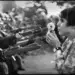 20 Powerful Photos That Froze Iconic Moments in History Forever 21 Young woman holding a flower facing armed soldiers
