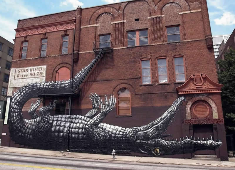 I love the way its tail comes down the stairs - Street Art Masterpieces Around the World