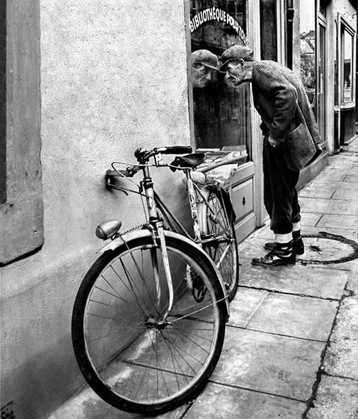 Elderly man walking with a bicycle on the street - Black and White Bicycle Photos of Everyday Life
