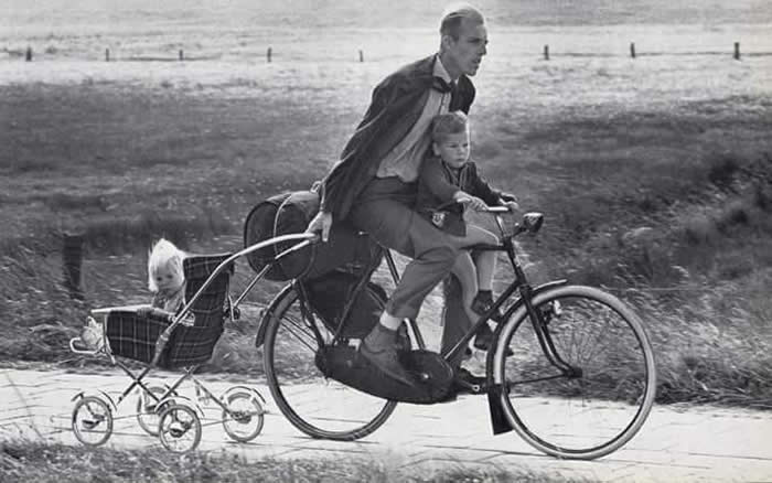 Father riding a bicycle with his two children - Black and White Bicycle Photos of Everyday Life