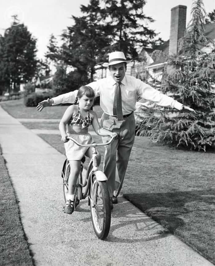 Father and child enjoying a bicycle ride - Black and White Bicycle Photos of Everyday Life
