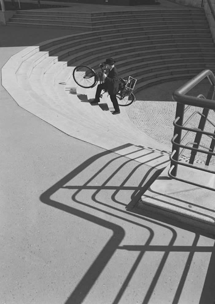 Man walking his bicycle down the steps - Black and White Bicycle Photos of Everyday Life