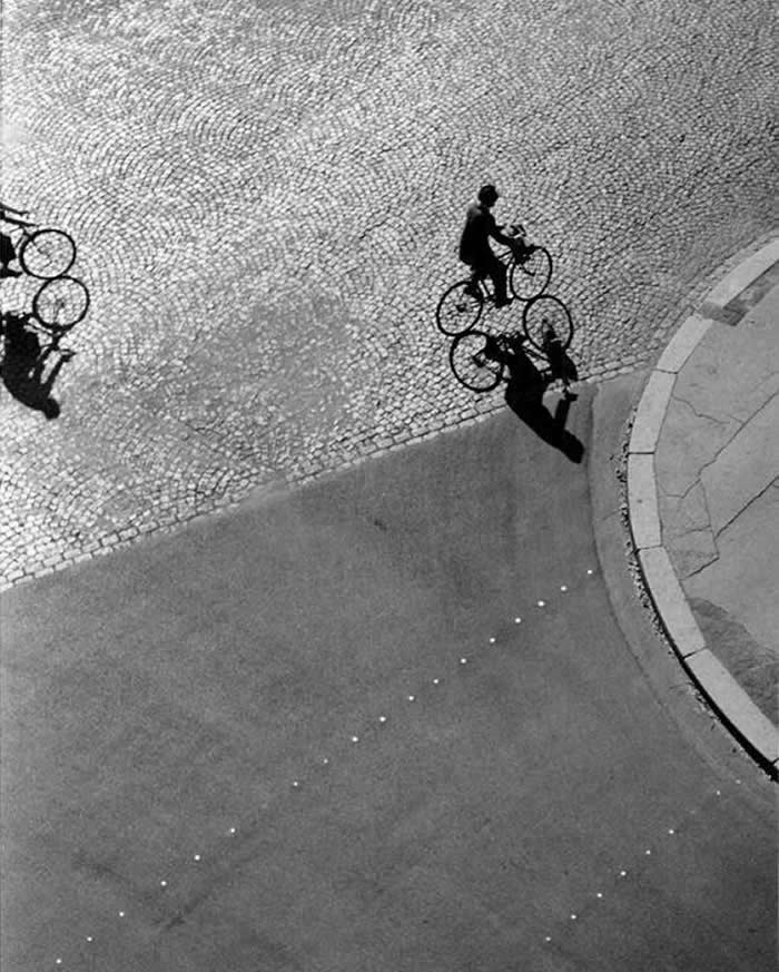Man cycling alone through an empty street - Black and White Bicycle Photos of Everyday Life