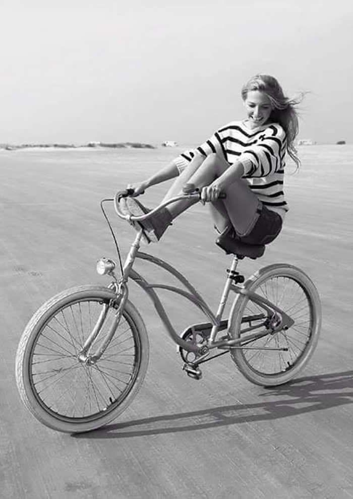 Girl riding a bicycle along the beach - Black and White Bicycle Photos of Everyday Life