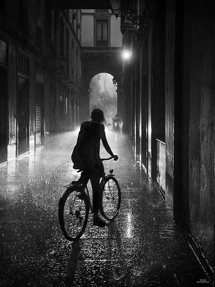 Bicycle ride in the rain on a wet street - Black and White Bicycle Photos of Everyday Life