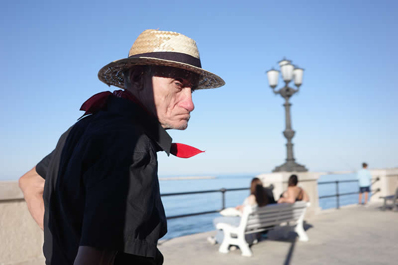The man with the straw hat and red handkerchief by Anna Marzia Soria, Italy - Street and Travel Photographs from the Chromatic Photography Awards