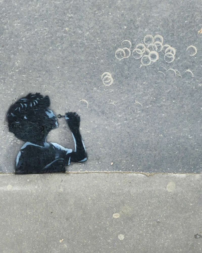 A little boy playing with water balloons - Funny Creative Street Artworks by Artist Oak Oak